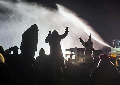 Police at Standing Rock target activists with water cannons in below-freezing temperatures