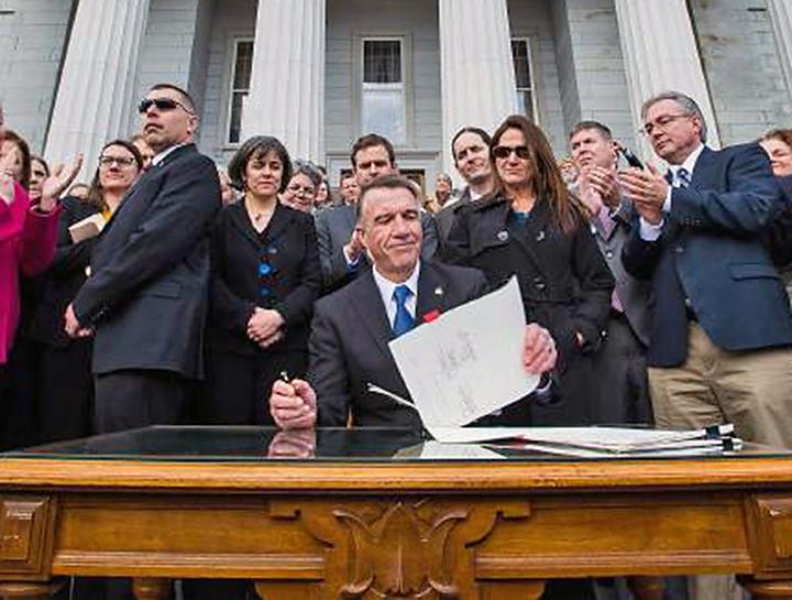Vermont Gov. Phil Scott signs gun control legislation outside the statehouse