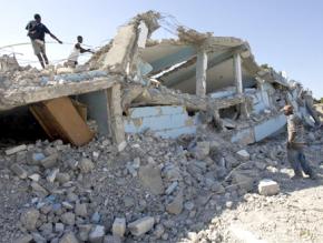 Kids search through the rubble of a school in Cité Soleil following the earthquake