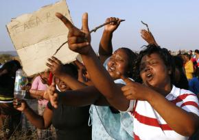 Miners and their families protest the police massacre that killed 34