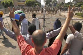 Supporters of the Muslim Brotherhood face a line of Egyptian soldiers in Nasr City
