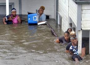 Katrina survivors make their way out of flooded buildings