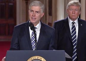 Neil Gorsuch speaks at a press conference while Trump looks on