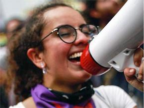 Juliana Vargas leads chants for marching students